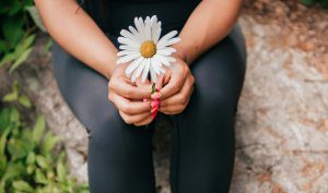 woman holding a flower